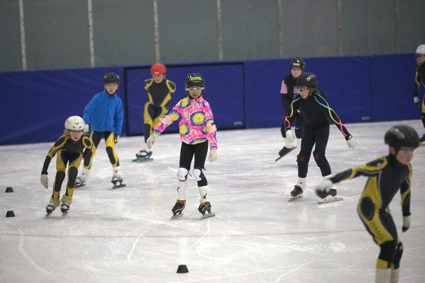 Hamilton speed skaters spread across the ice during a practice drill.