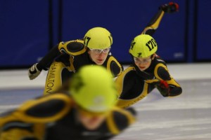 Three Hamilton and Golden Horseshoe speed skaters racing.